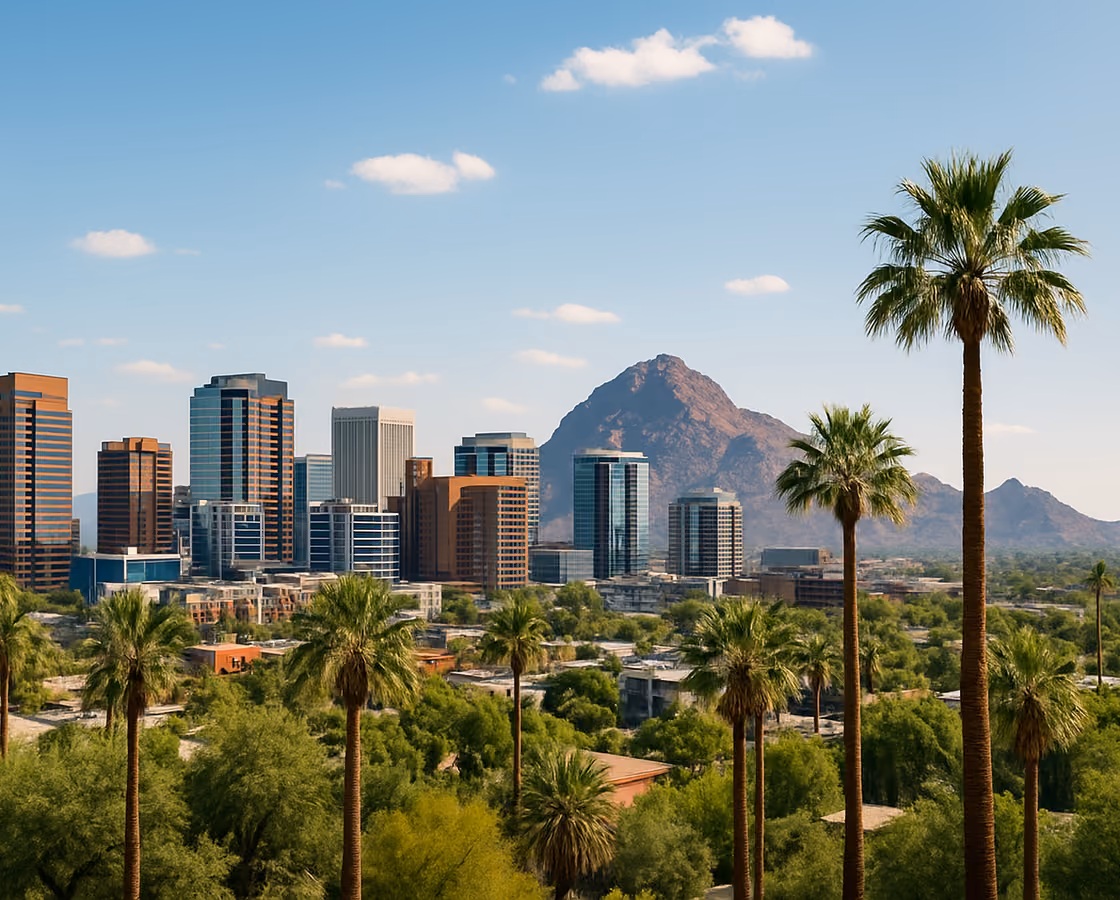 Downtown Phoenix, Arizona skyline with palm trees and Camelback Mountain in the distance