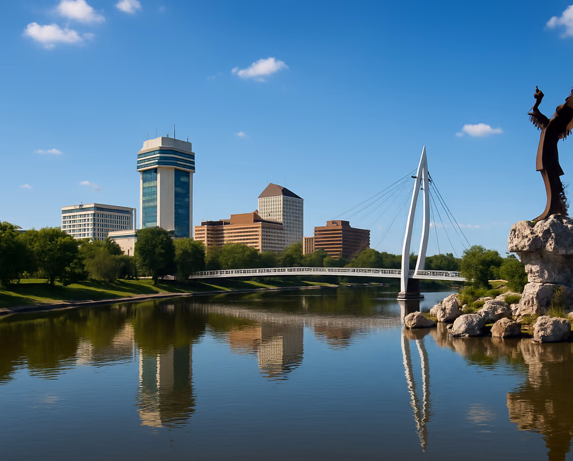 Downtown Wichita, Kansas skyline along the Arkansas River with the Keeper of the Plains sculpture